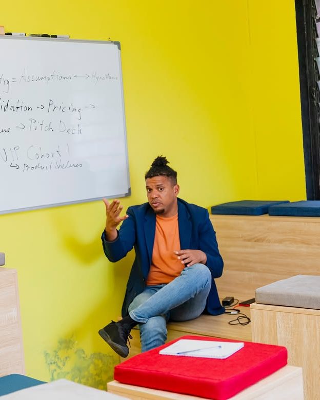 A facilitator talking a group through an idea at the whiteboard.